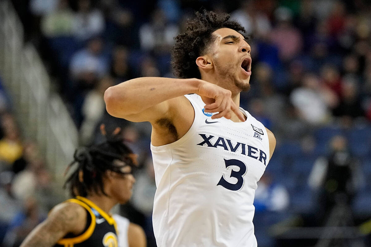 Xavier guard Colby Jones celebrates after scoring against Pittsburgh during the first half of a ...