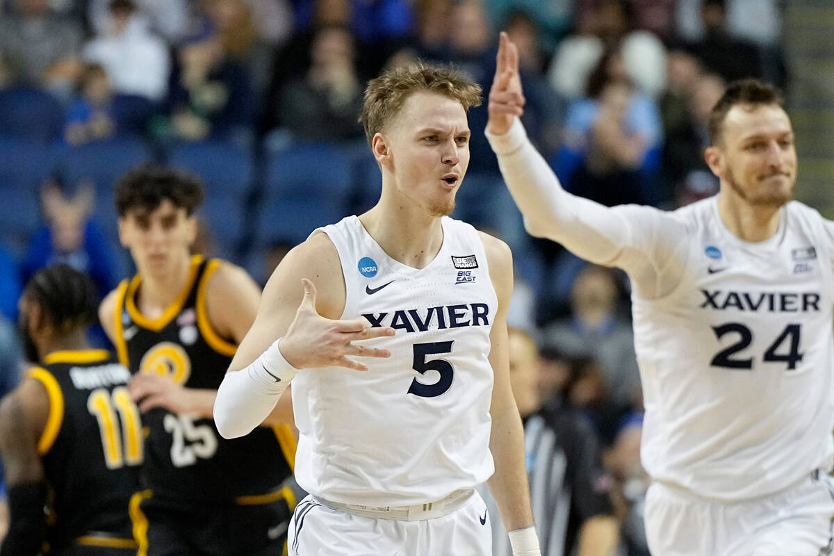 Xavier guard Adam Kunkel celebrates after scoring against Pittsburgh during the first half of a ...