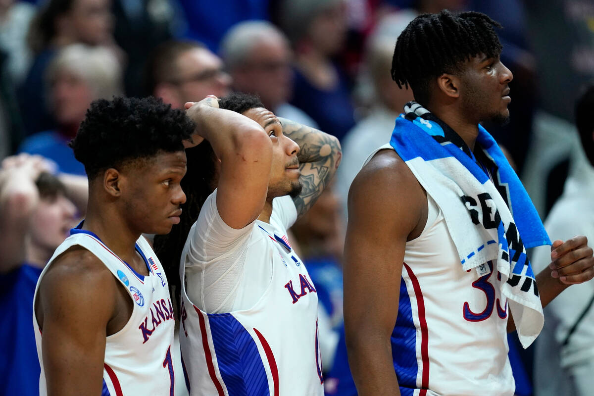 Kansas players watch from the bench in the second half of a second-round college basketball gam ...