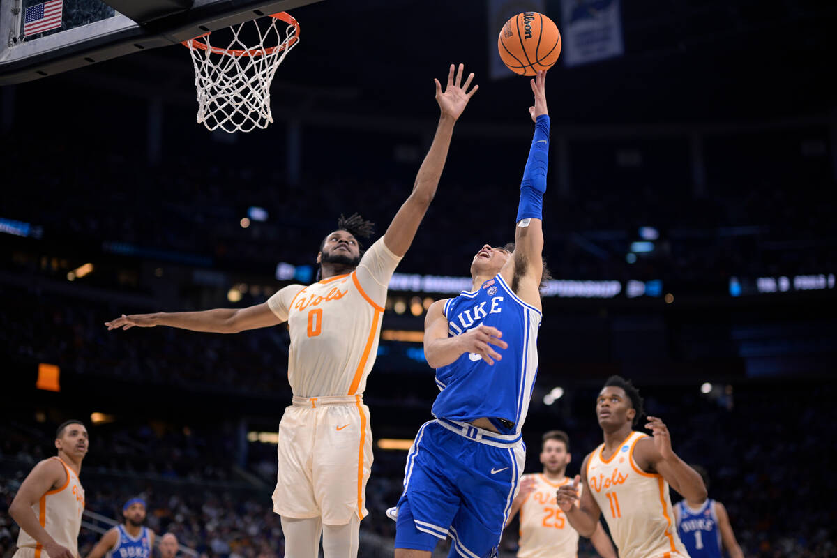 Duke guard Tyrese Proctor (5) goes up for a shot as Tennessee forward Jonas Aidoo (0) defends d ...
