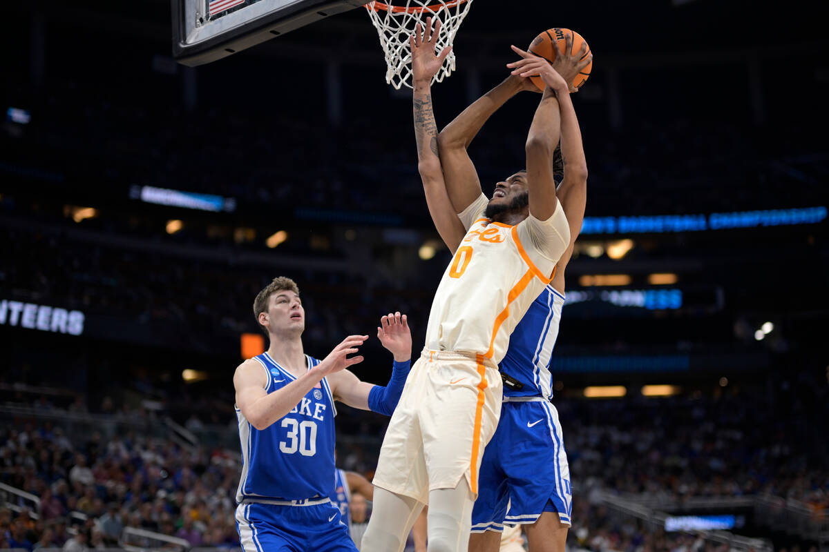 Tennessee forward Jonas Aidoo (0) is fouled by Duke center Dereck Lively II while going up for ...
