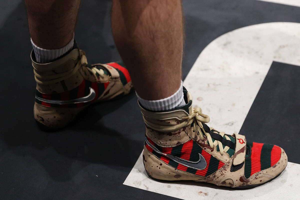 Caleb Plant stands on the ring wearing custom Nike "Freddy Krueger" boxing shoes duri ...