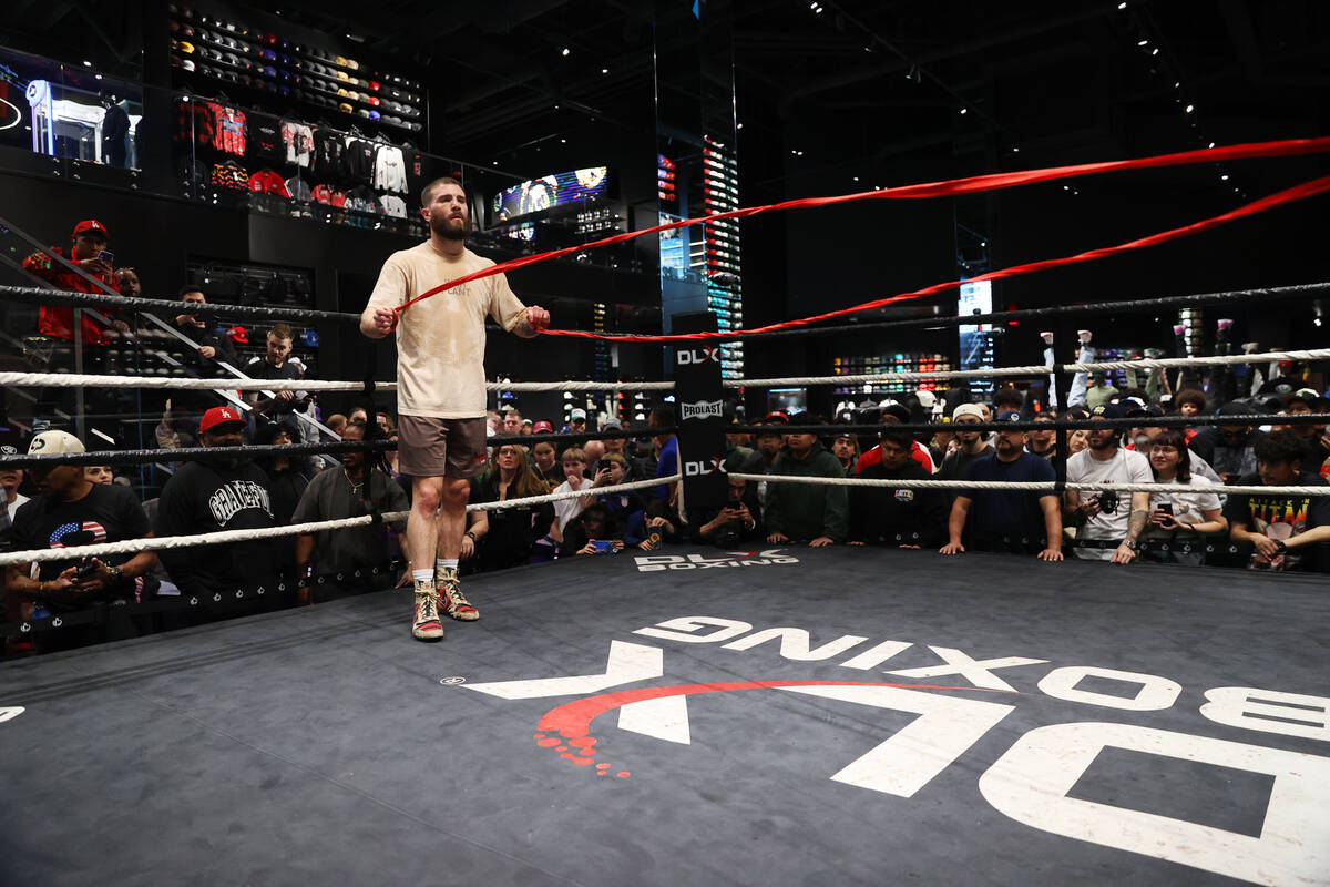 Caleb Plant removes his hand wraps during a media workout at Culture Kings at The Forum Shops i ...