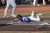 Basic’s Troy Southisene scores a run against Green Valley during a baseball game at Basi ...