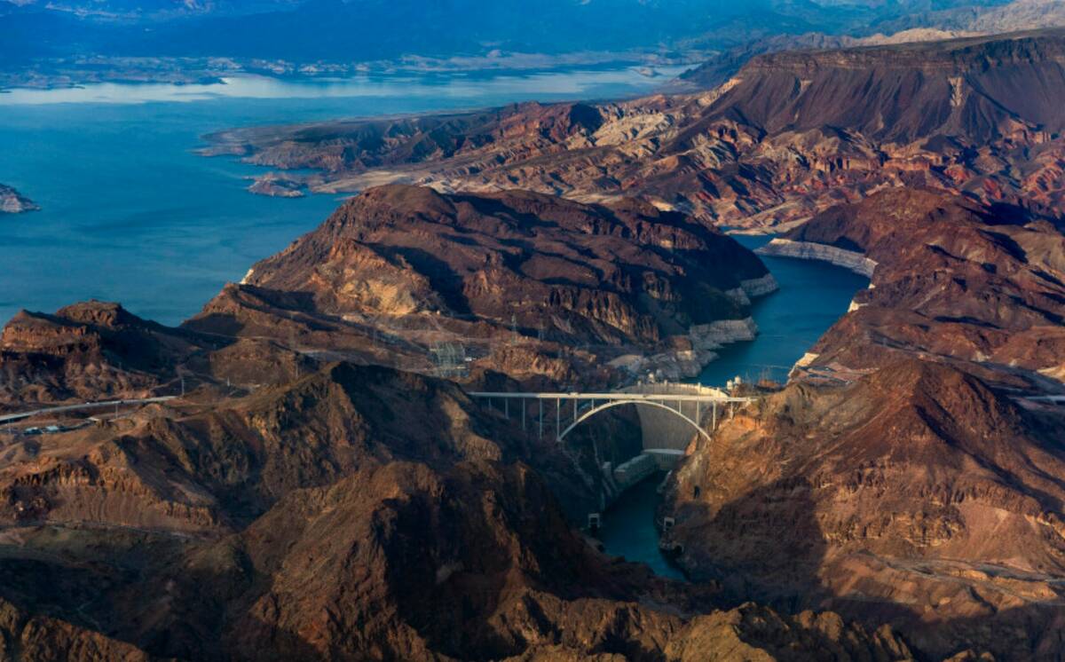 The Hoover Dam with the lower Lake Mead shoreline, above, and Colorado River continuing below o ...