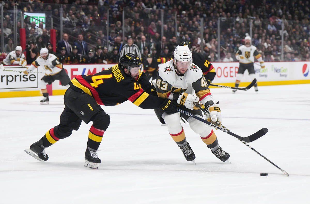 Vancouver Canucks' Kyle Burroughs, left, checks Vegas Golden Knights' Paul Cotter during the se ...