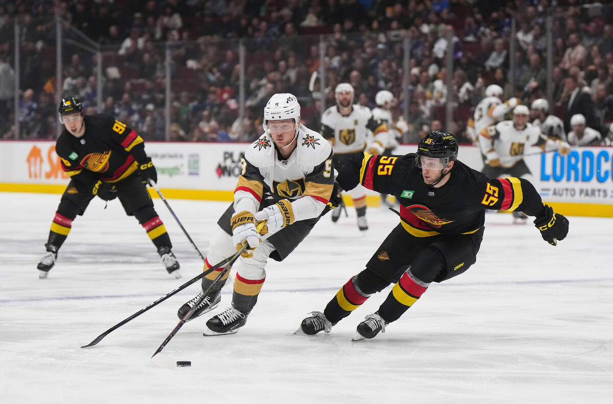 Vegas Golden Knights' Jack Eichel (9) skates with the puck past Vancouver Canucks' Guillaume Br ...