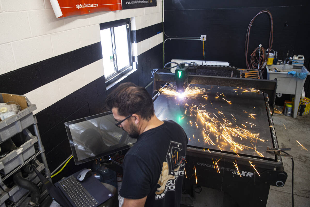 Custom Motor Sports fabricator Dick Bushman uses a plasma table to cut out a cover for a cataly ...