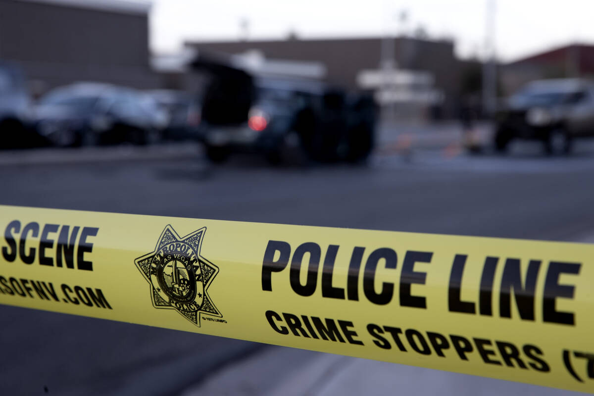 Police tape marks the scene of a fatal car crash at the intersection of West Desert Inn Road an ...