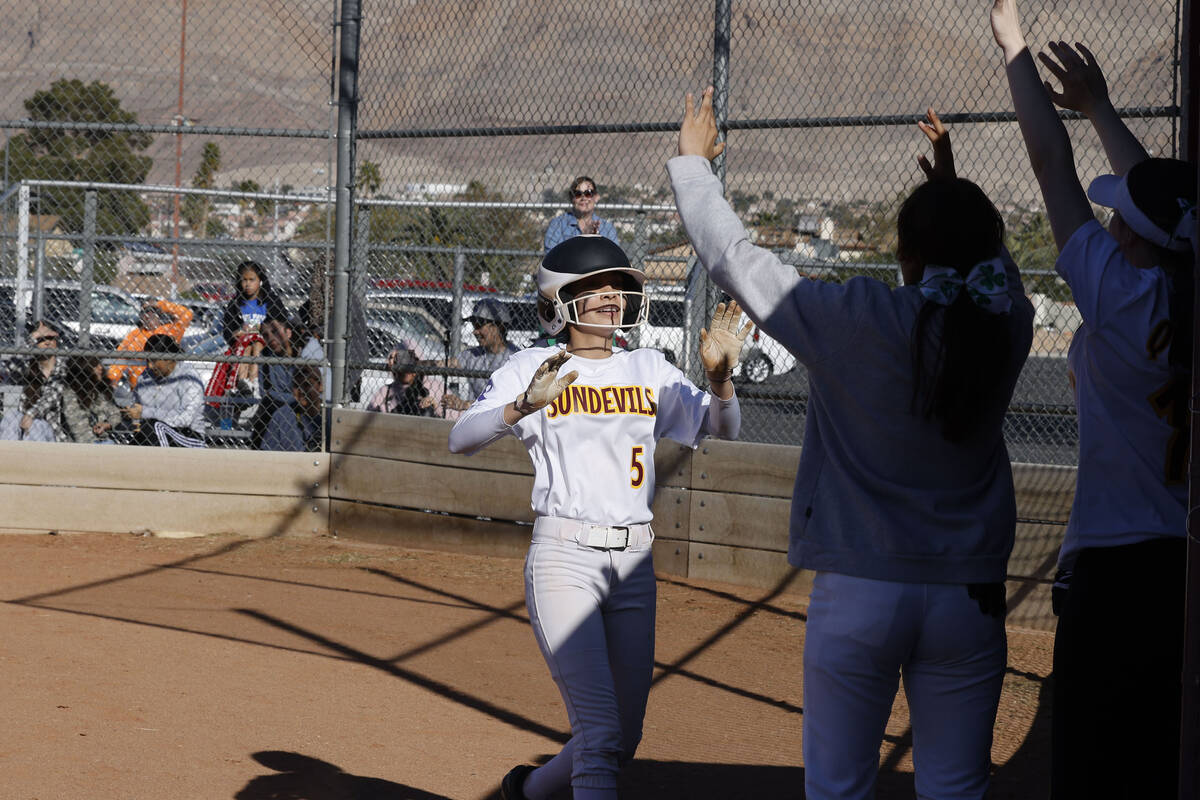 Eldorado teammates greet Erica Madrid (5) after her inside-the-park home run during the second ...