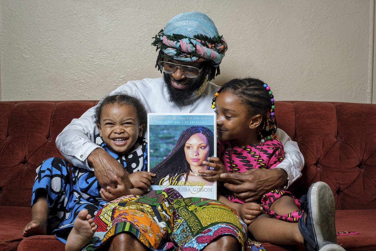 In this photo provided by Henry Danner, Omari Maynard sits with his children, Khari, left, and, ...