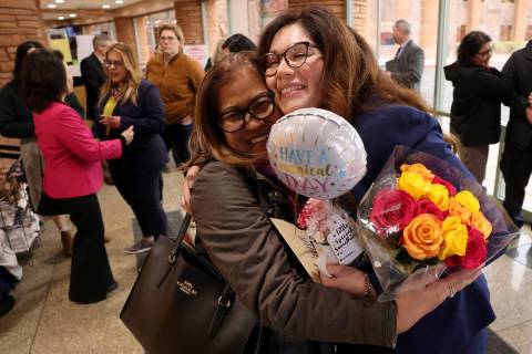Clark County Registrar of Voters Lorena Portillo, right, hugs Amy Nicolas, with Filipino Americ ...