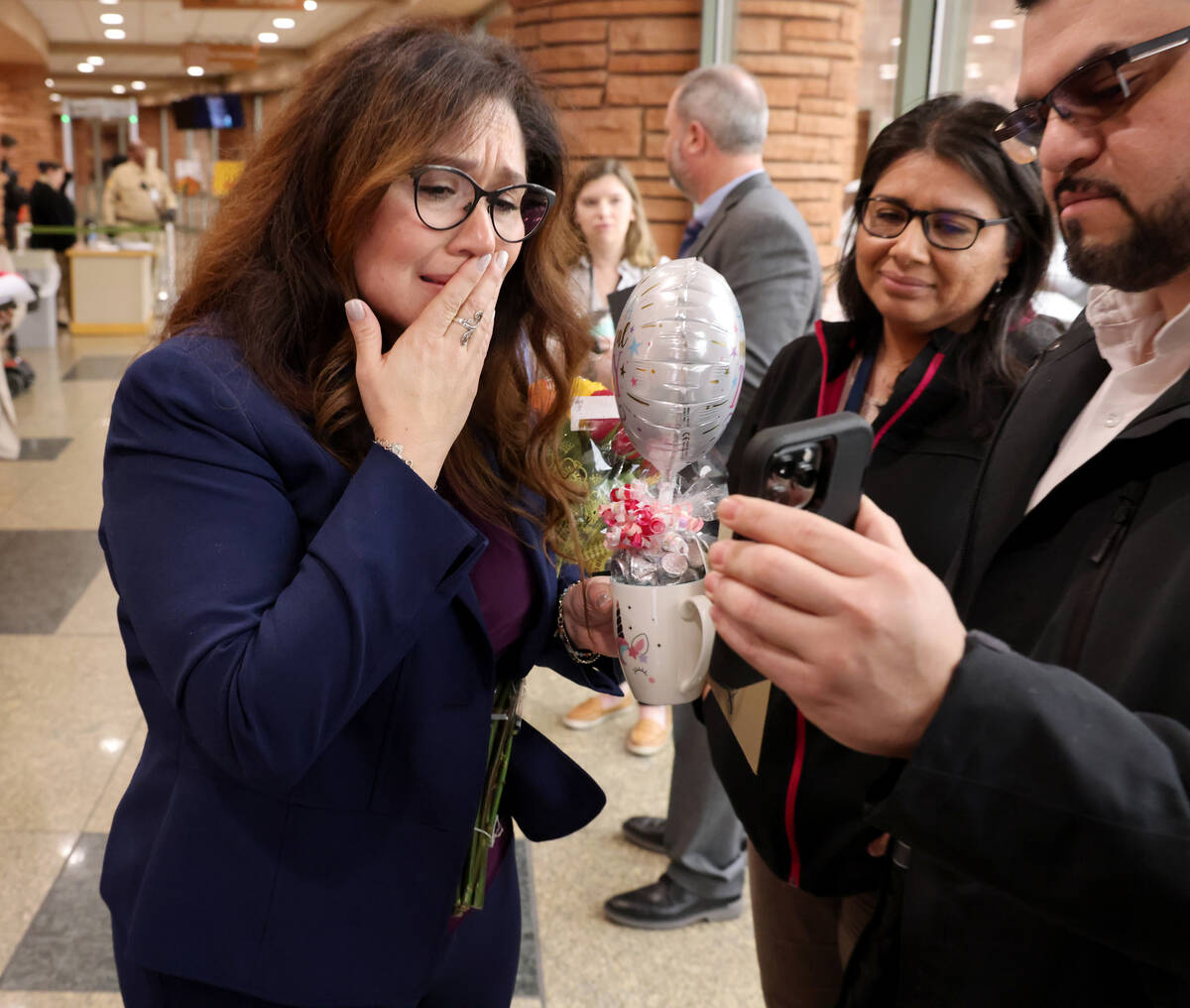 Clark County Registrar of Voters Lorena Portillo, right, gets emotional as she talks to her fat ...