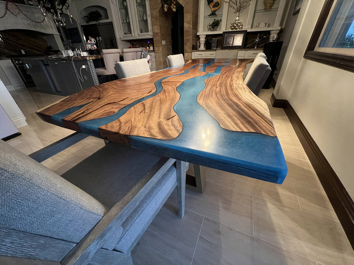 Live Edge Slabs of Las Vegas River tables use epoxy with a blue or green hue that is poured int ...