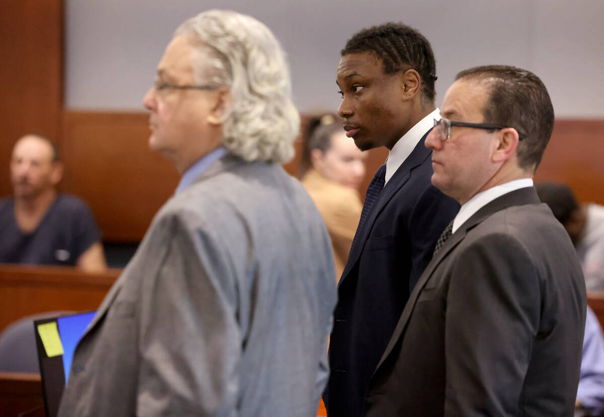 Former Raiders player Henry Ruggs, center, appears in court with his attorneys David Chesnoff, ...