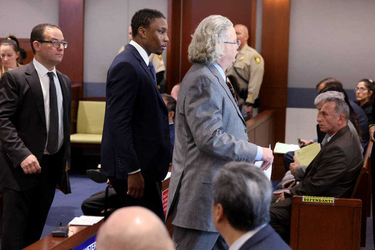 Former Raiders player Henry Ruggs, center, leaves court with his attorneys David Chesnoff, righ ...