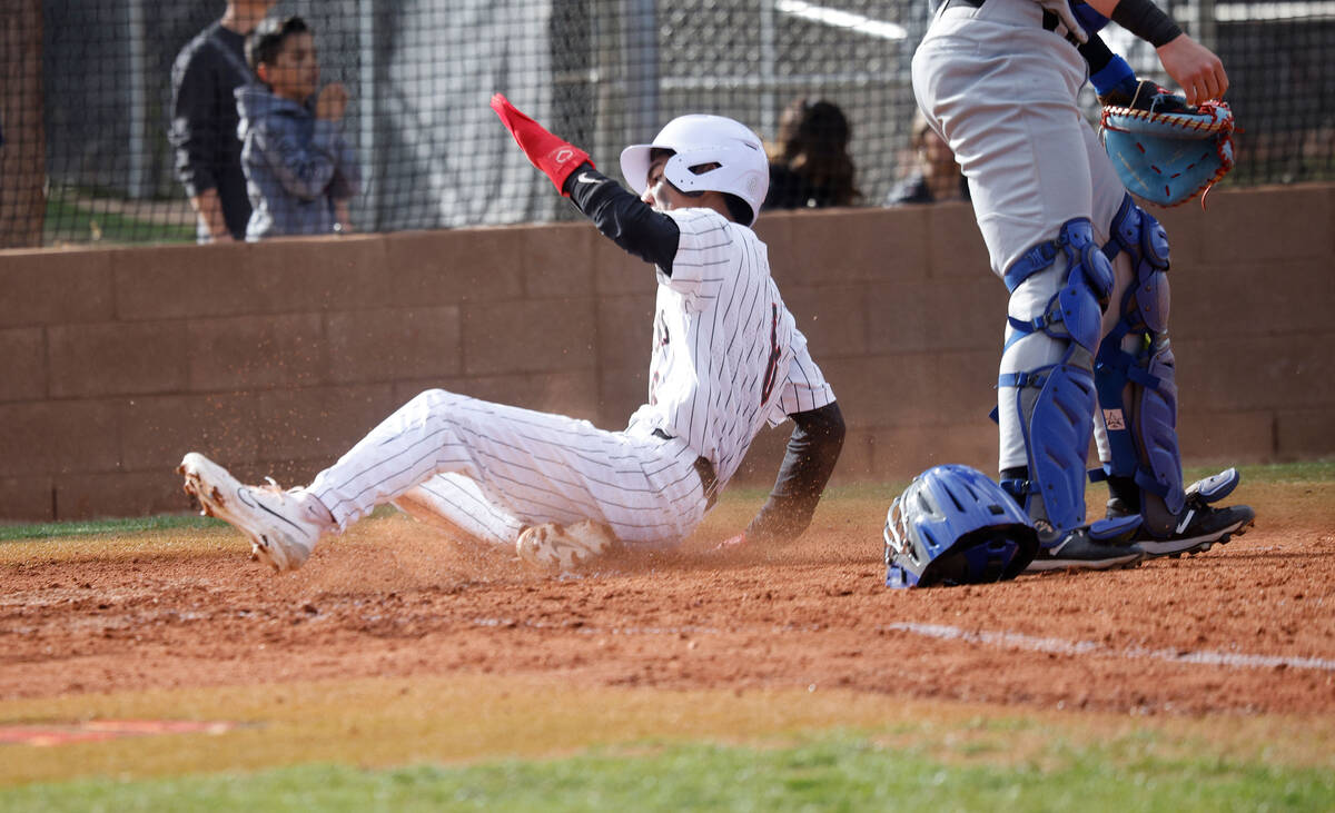 Desert Oasis' Connor Jacob (8) scores on a single by Desert Oasis' Noah Griffith (17) during th ...