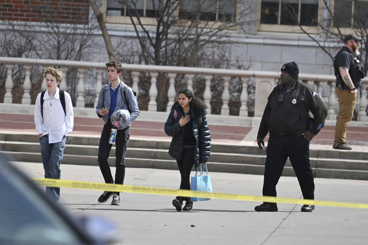 Students leave East High School following a school shooting, Wednesday, March 22, 2023, in Denv ...