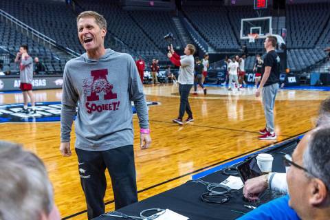 Arkansas head coach Eric Musselman laughs with writers as his players shoot around during the W ...