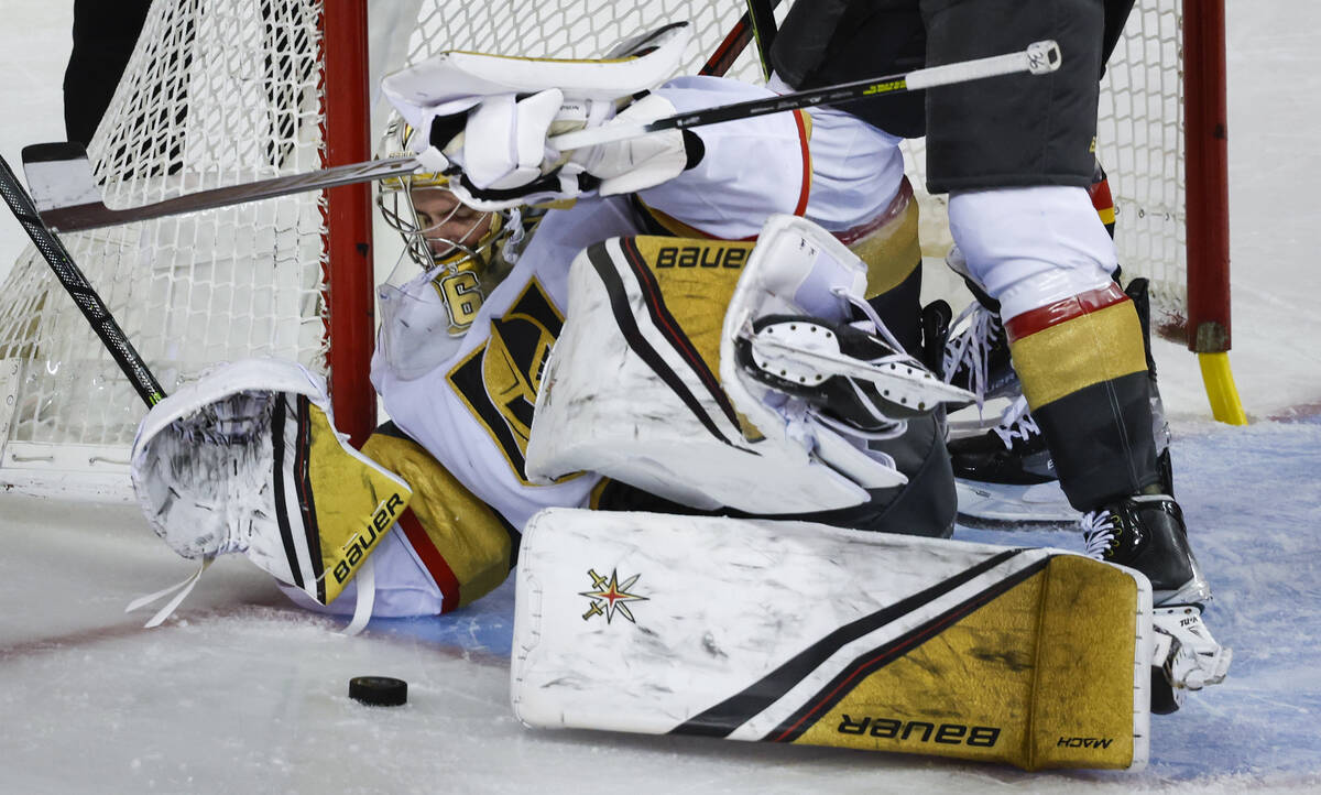 Vegas Golden Knights goalie Logan Thompson scrambles to block the net during third-period NHL h ...