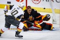 Vegas Golden Knights forward Nicolas Roy, left, scores against Calgary Flames goalie Jacob Mark ...