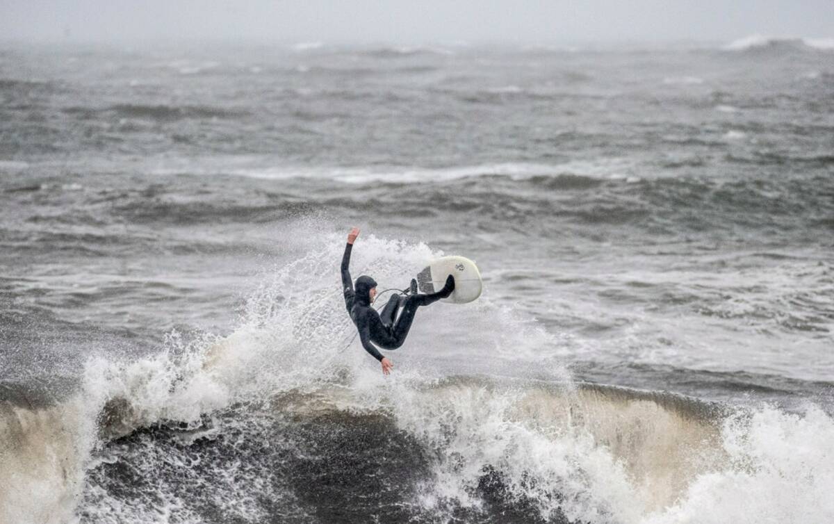 A surfer rides his board at Cowell Beach during the latest atmospheric storm event in Santa Cru ...