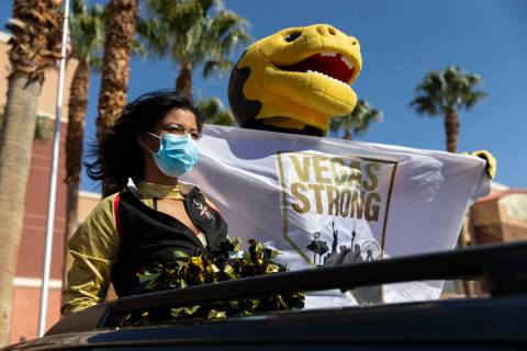 Golden Knights mascot Chance, top/right, and a member of the Golden Aces cheer for Mountain Vie ...