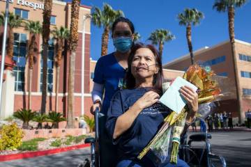 MountainView Hospital nurse Bessy Angue, bottom right, is wheeled out of Southern Hills Hospita ...