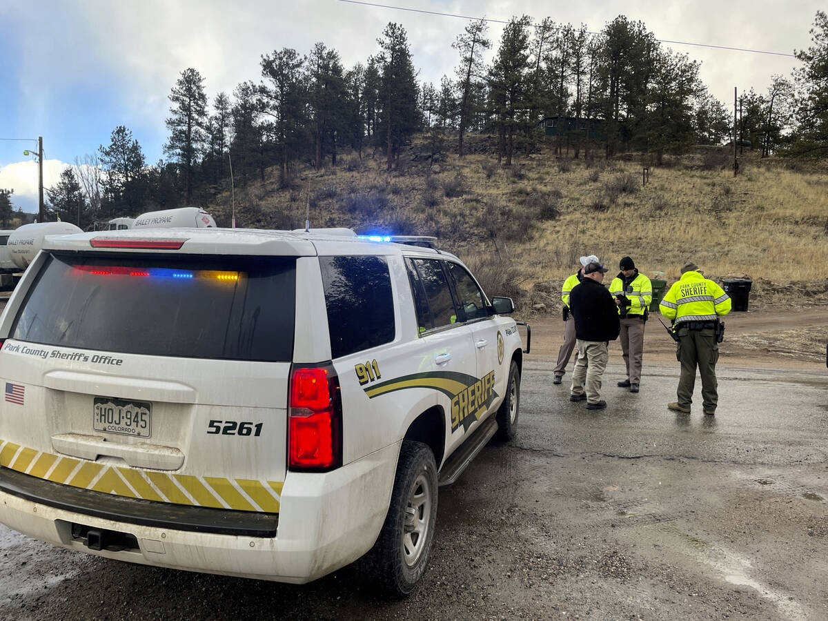 Sheriff deputies block a road in the town of Bailey, Colo., where authorities found an abandone ...