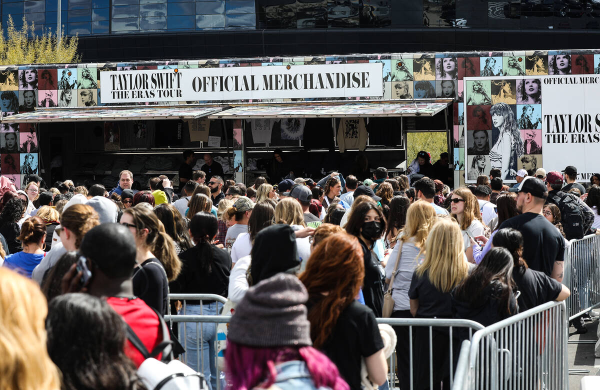 Fans wait in line for Taylor Swift merchandise at a pop-up store outside Allegiant Stadium in L ...