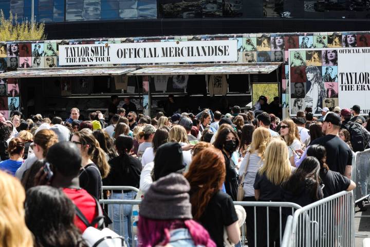 Fans wait in line for Taylor Swift merchandise at a pop-up store outside Allegiant Stadium in L ...