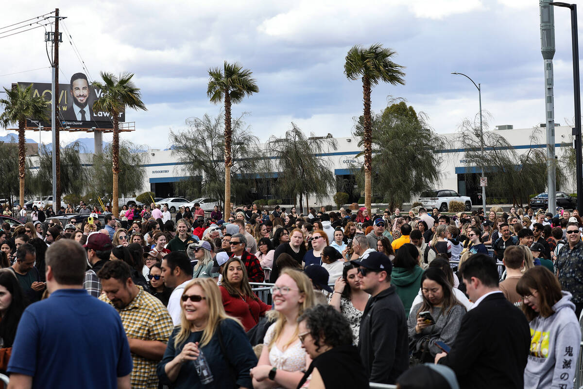 Fans wait in line for Taylor Swift merchandise at a pop-up store outside Allegiant Stadium in L ...