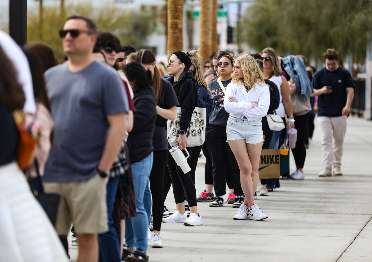 Fans wait in line for Taylor Swift merchandise at a pop-up store outside Allegiant Stadium in L ...
