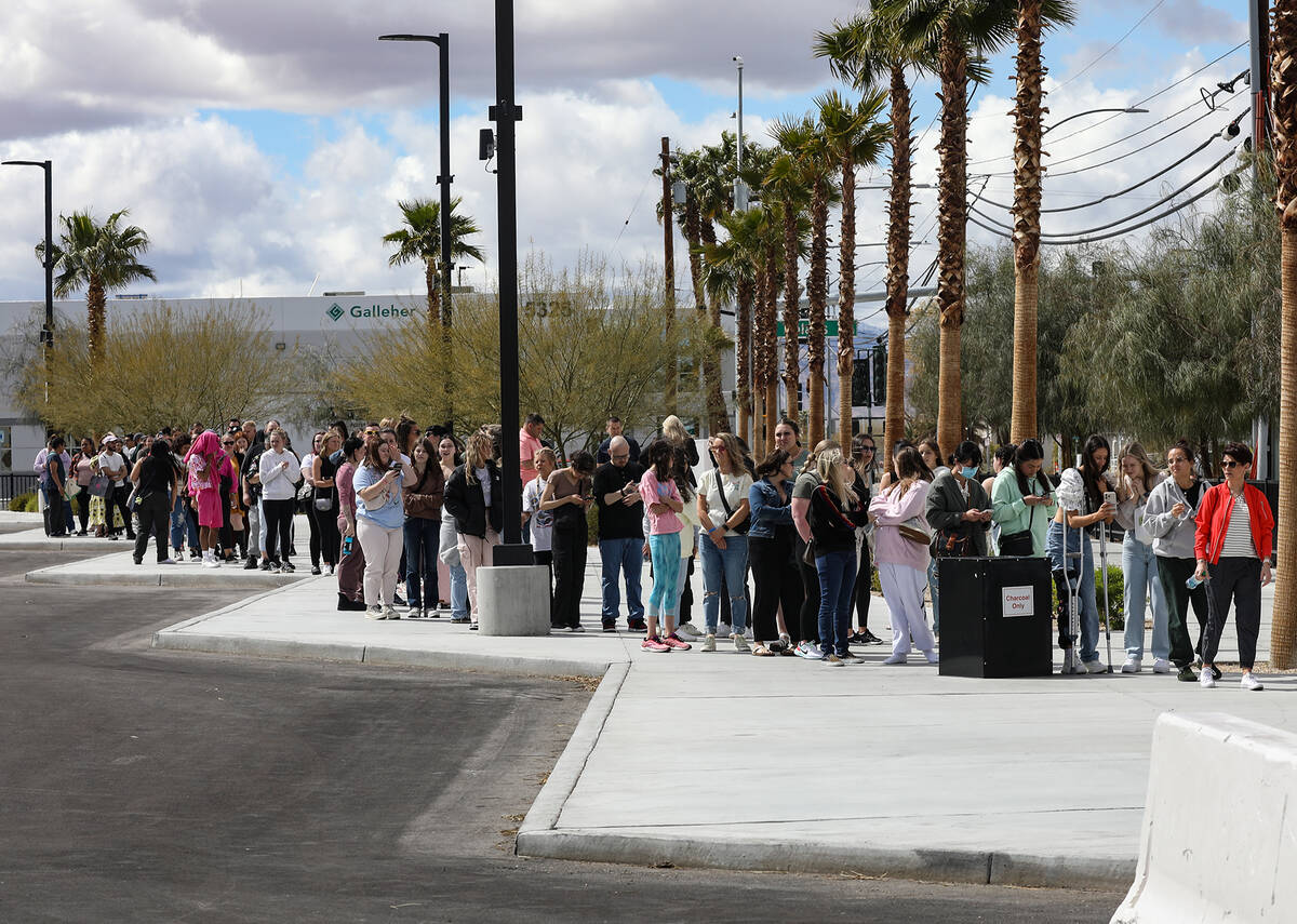 Fans wait in line for Taylor Swift merchandise at a pop-up store outside Allegiant Stadium in L ...