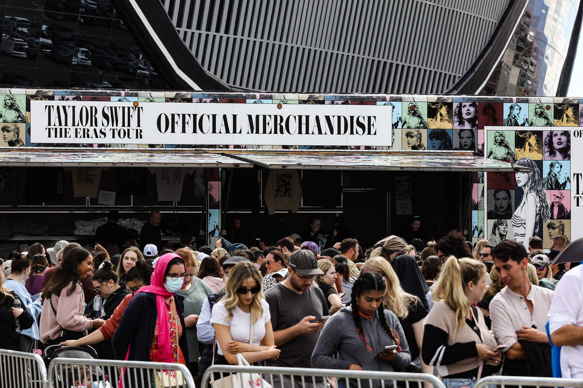 Fans wait in line for Taylor Swift merchandise at a pop-up store outside Allegiant Stadium in L ...