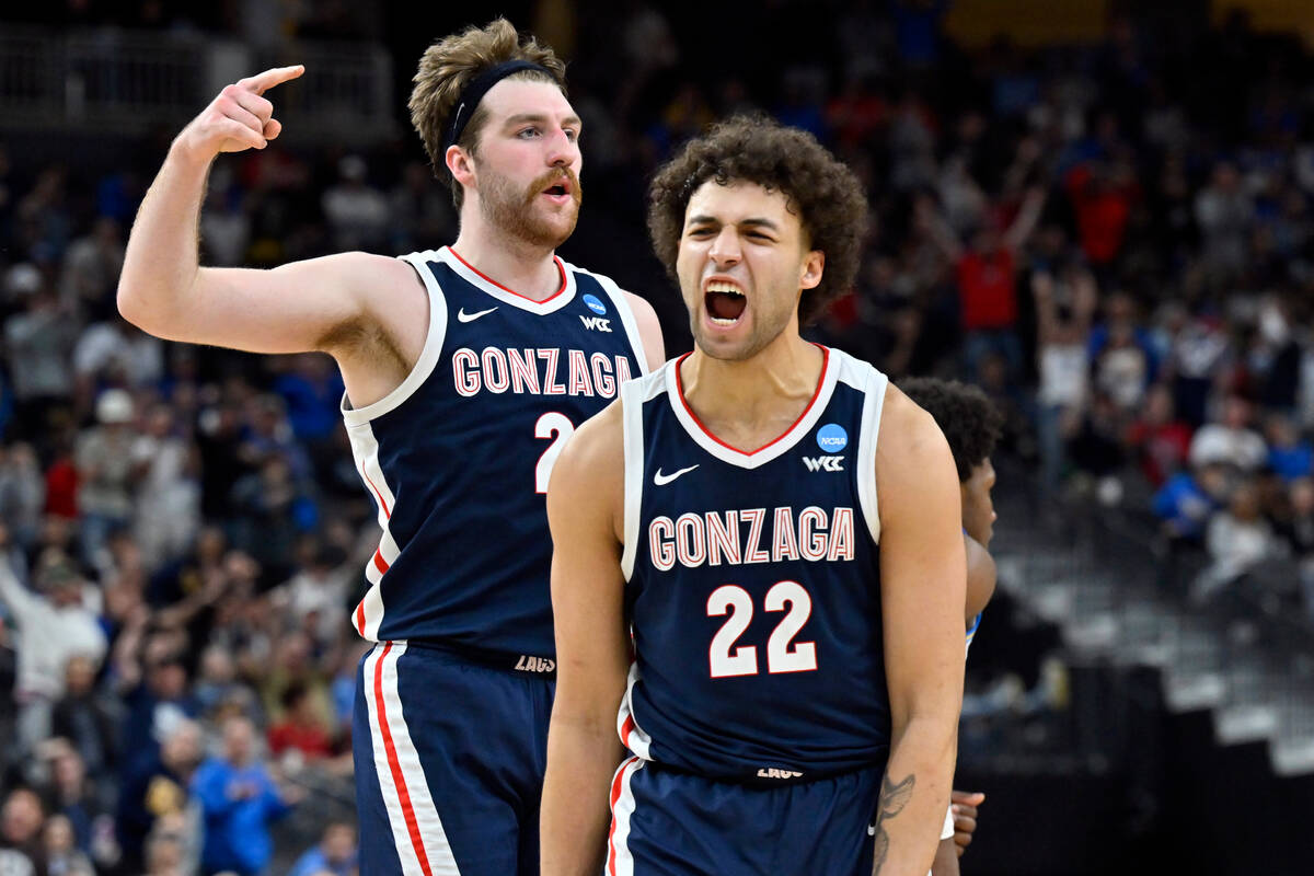 Gonzaga's Anton Watson (22), front, and Drew Timme react in the second half of a Sweet 16 colle ...