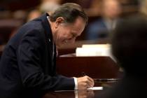 Assemblyman Richard McArthur, R-Las Vegas, signs his oath of office during the first day of the ...