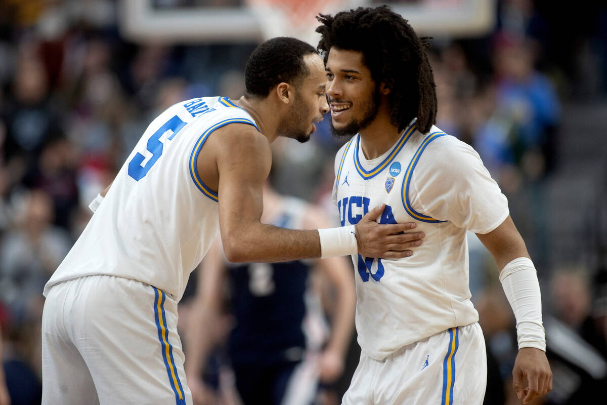 UCLA Bruins guard Amari Bailey (5) and guard Tyger Campbell (10) celebrate as their team is in ...