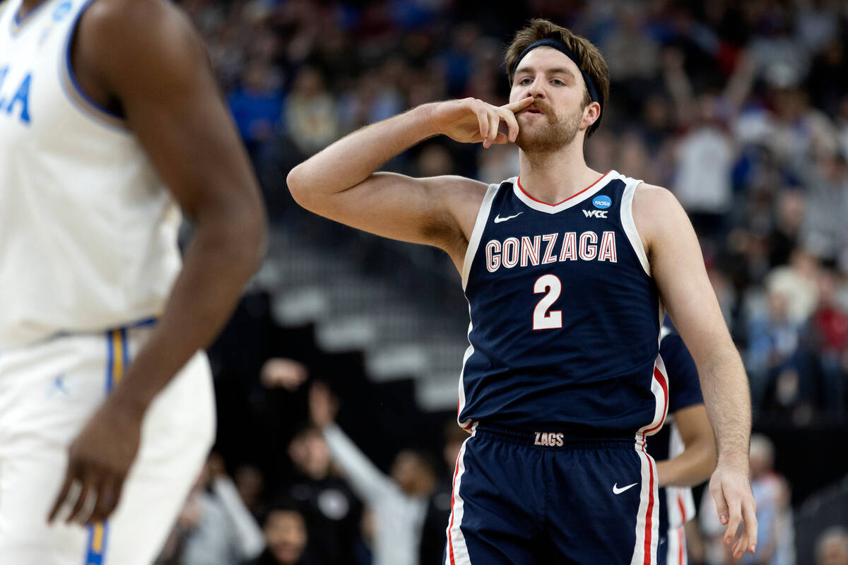 Gonzaga Bulldogs forward Drew Timme (2) swipes his mustache after scoring during the first half ...