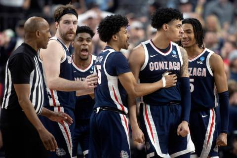 The Gonzaga Bulldogs surround guard Julian Strawther (0) after he scored a late three-pointer d ...