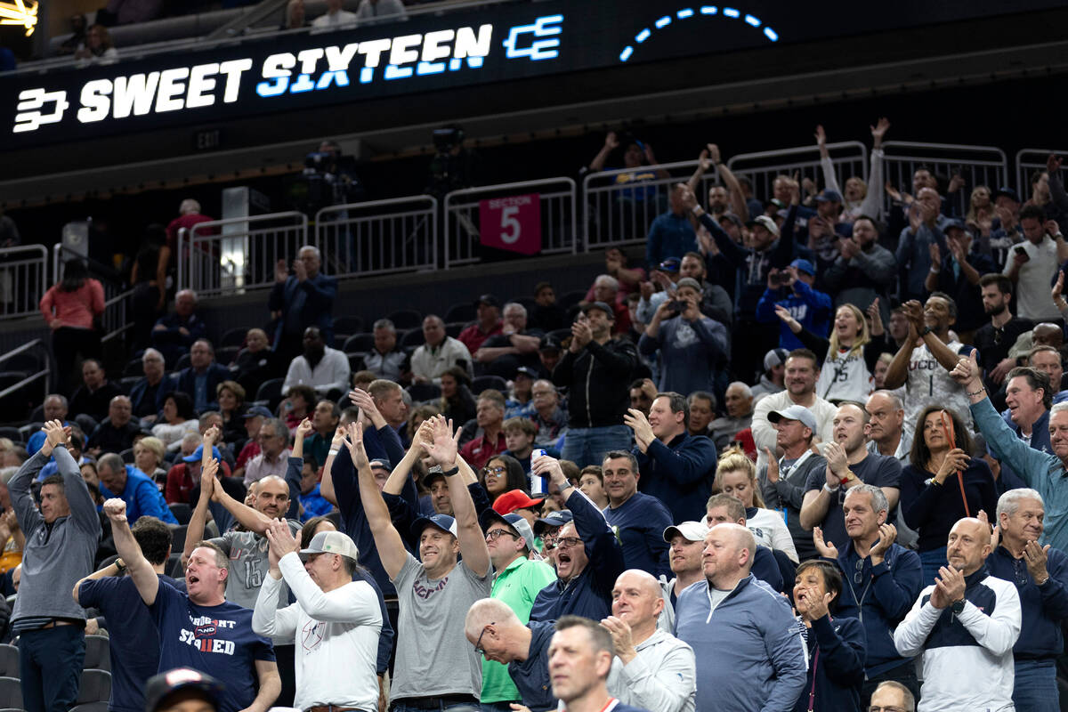 Connecticut Huskies fans cheer for their team after they won a West Regional NCAA semifinal gam ...