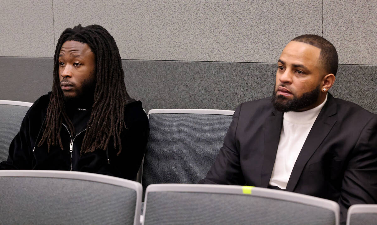 New Orleans Saints running back Alvin Kamara, left, waits in court for arraignment with one of ...