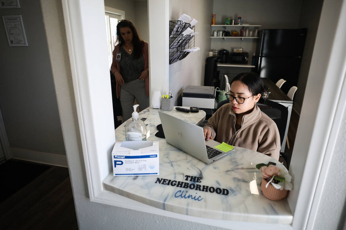 Angela Manalo works the front desk at The Neighborhood Clinic inside the site of the Las Vegas ...