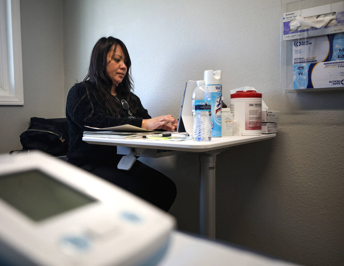 Rose Manalo, medical assistant, works in a patient room at The Neighborhood Clinic inside the s ...