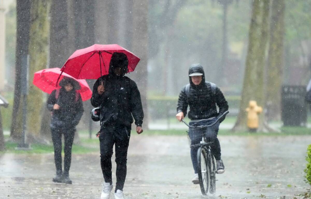 Rain falls on pedestrians on the University of Southern California campus on Tuesday, March 21, ...