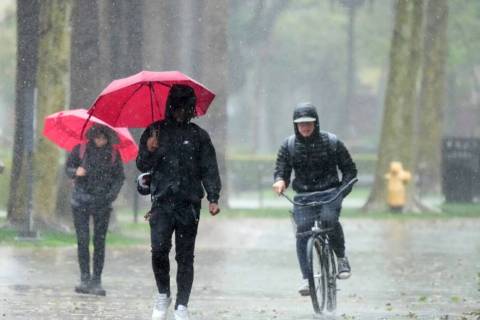 Rain falls on pedestrians on the University of Southern California campus on Tuesday, March 21, ...