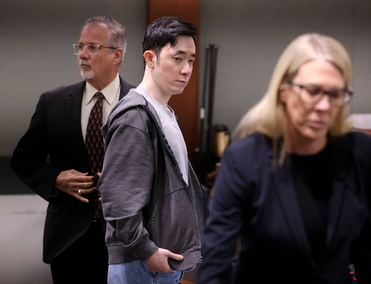 Chan Park, center, stands as the jury returns to the courtroom at the Regional Justice Center i ...