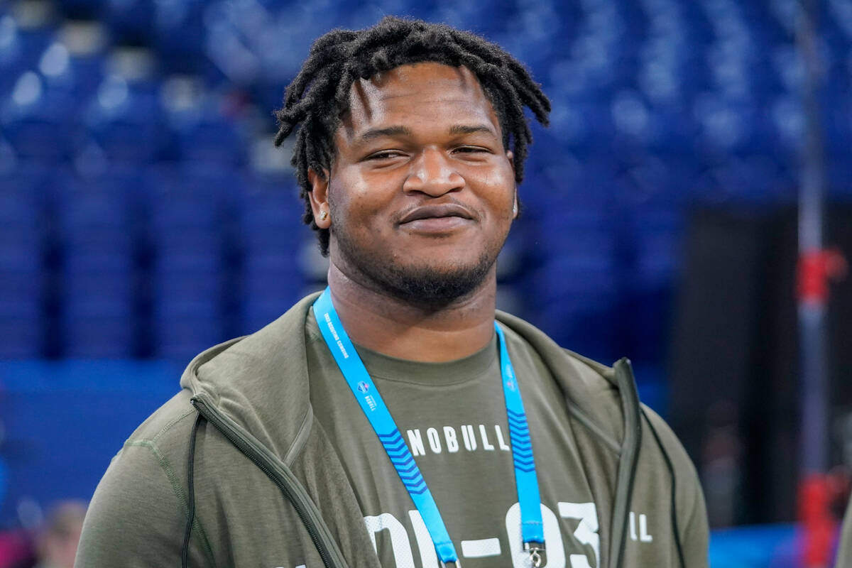 Georgia defensive lineman Jalen Carter watches as players warm up on the field before the NFL f ...