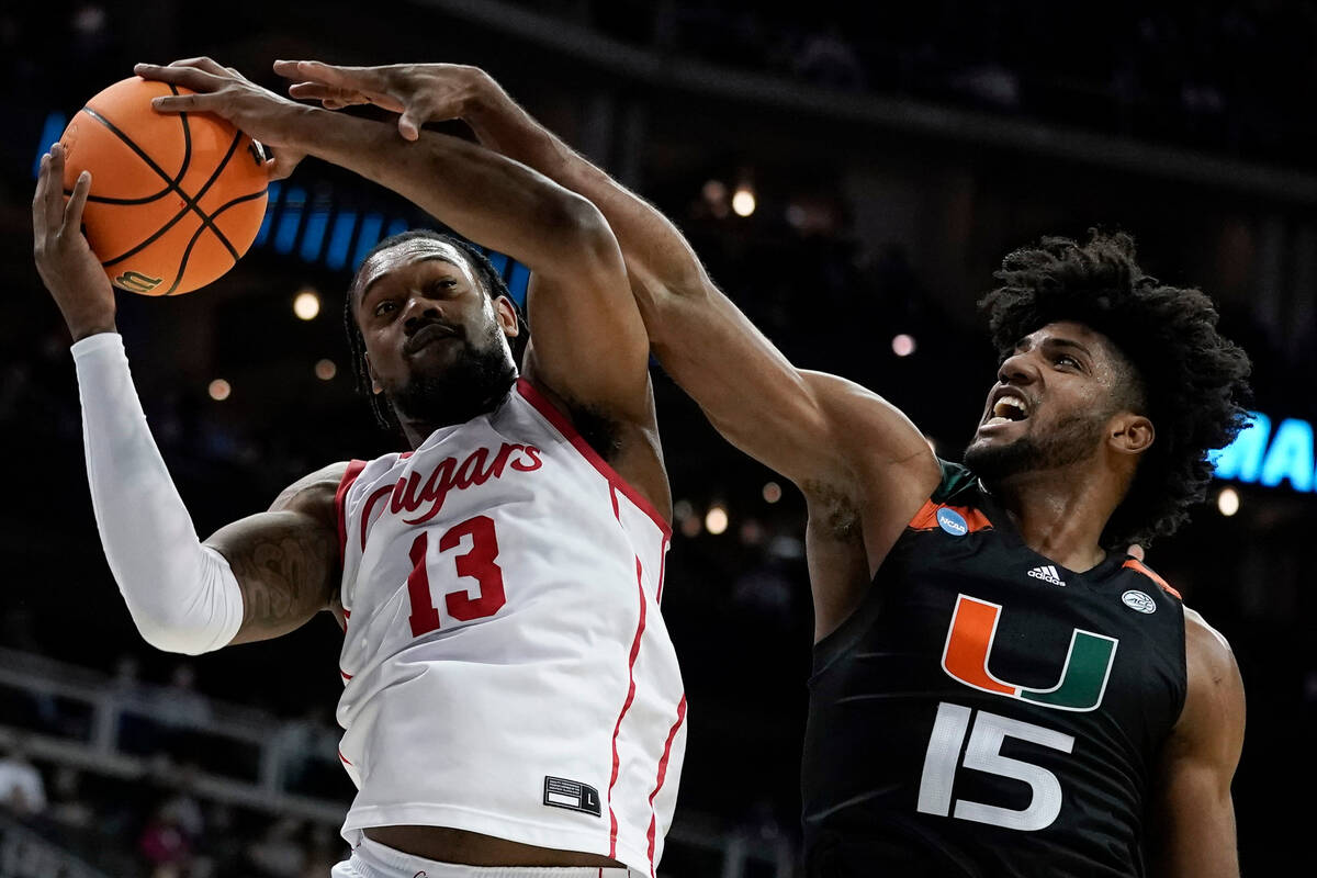 Miami forward Norchad Omier blocks a shot by Houston forward J'Wan Roberts in the first half of ...