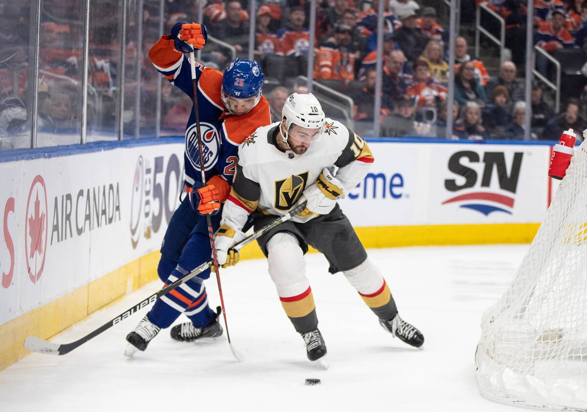 Vegas Golden Knights' Nicolas Roy (10) and Edmonton Oilers' Darnell Nurse (25) compete for the ...